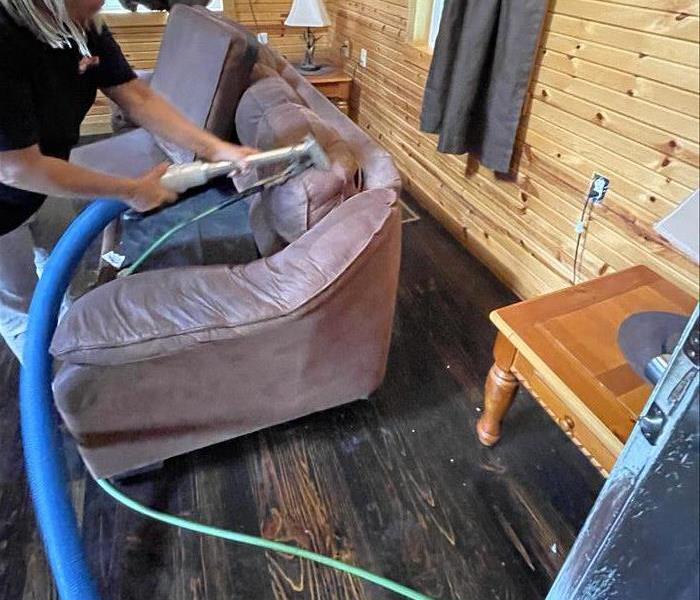 Employee steaming and extracting furniture 