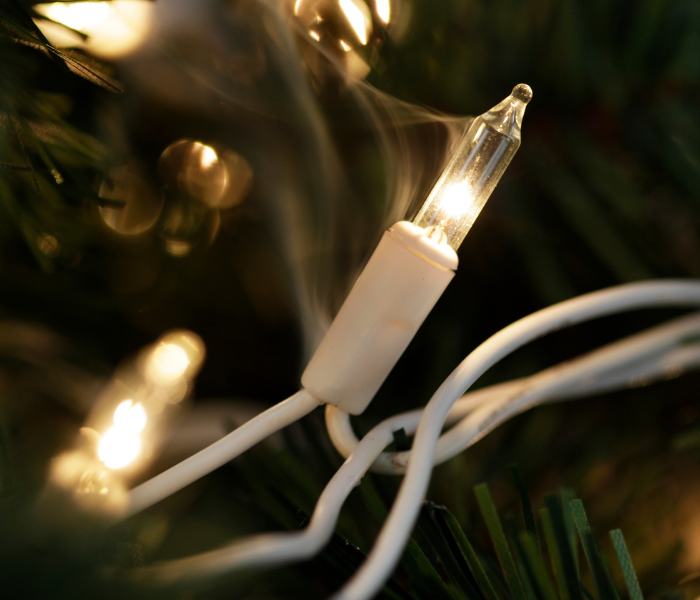 close-up shot of a Christmas tree light starting to smoke