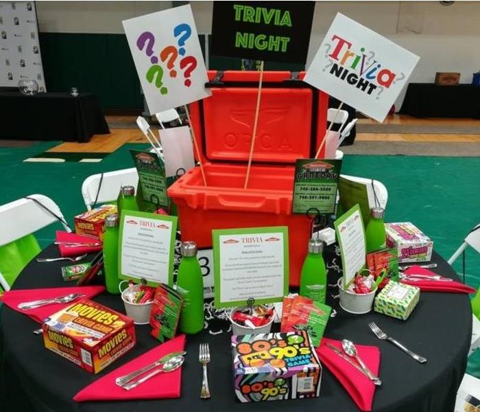 Table decorated with Trivia Games and SERVPRO branded items.