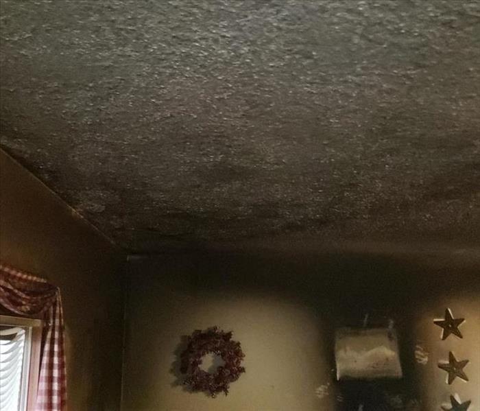 Smoke and soot damage to the walls and ceiling of a residential property